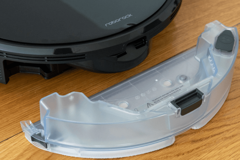 The water tank of the Roborock S6 MaxV is behind the robot vacuum.